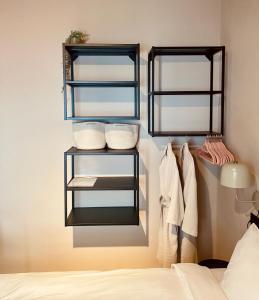 a room with two shelves with towels and a bed at Casita 10 Málaga, holiday home with roof terrace in Málaga