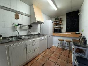 a kitchen with white cabinets and a sink and a counter at Molino del Corregidor in San Román de Cameros