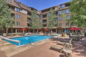 a hotel with a swimming pool and tables and chairs at Keystone Ski Condo with Mtn View - Walk to Gondola! in Keystone