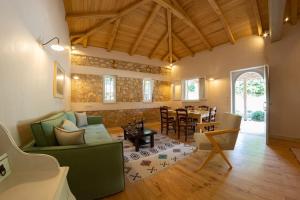 a living room with a couch and a table at AVLI - Tranquil stonehouse in Lefkada in Alexandros +14 photos