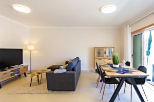 a living room with a table and a dining room at Welcome Cabanas Beach in Cabanas de Tavira