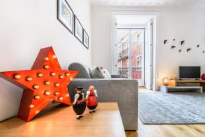 a living room with a star and two penguins in front of a couch at Modern Flat in Downtown Lisbon by LovelyStay in Lisbon