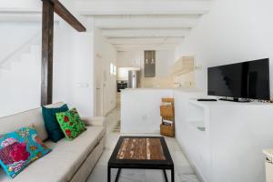 a living room with a couch and a table at El Erizo Apartamentos in Tarifa