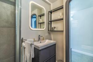 a bathroom with a sink and a mirror at Stella by PortofinoHomes in Portofino