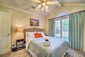 a bedroom with a bed with a ceiling fan and a window at Lubbock Home with Patio about 6 Mi to Texas Tech! in Lubbock