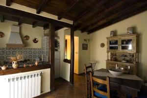 a kitchen with a table and a dining room at Villa Ivoni 1 in Campofelice di Roccella