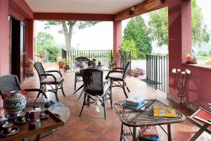 a patio with chairs and a table on a porch at Villa Ivoni 1 in Campofelice di Roccella
