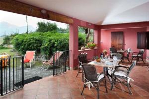 a patio with a table and chairs on a porch at Villa Ivoni 1 in Campofelice di Roccella