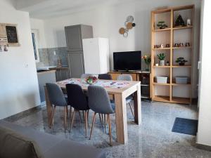 a kitchen with a table and chairs in a room at Ema in Brela