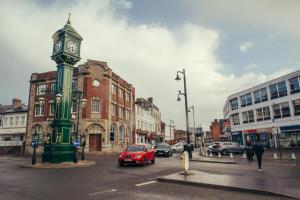 a clock tower in the middle of a city street at Luxury Comfort 1 bedroom Suite in Birmingham