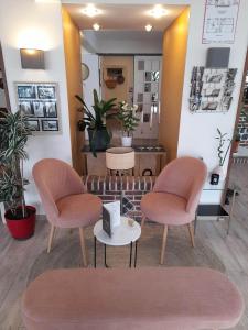 a waiting room with two chairs and a table at Hotel bar Saint Christophe in Le Tilleul