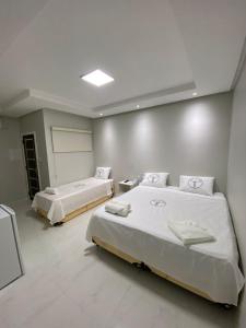 CastanhalにあるHotel Castanhalのベッド2台が備わる広い客室です。