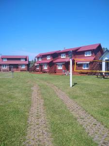 a dirt road in front of a large building at OW HOLIDAY Wicie in Wicie