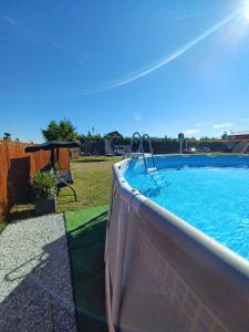 a swimming pool with a table and a swing at OW HOLIDAY Wicie in Wicie