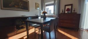 a dining room with a table and chairs and a dresser at APPARTAMENTO HEIDI IN CENTRO STORICO in Lazise