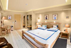 a bedroom with a large bed with blue pillows at Hotel Rössle in Dobel