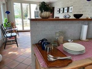 a kitchen counter with plates and utensils on a table at Skønne værelser med adgang til pejsestue og have in Risskov