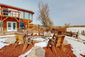 a group of chairs sitting in front of a house at Rio Grande Lodge in South Fork