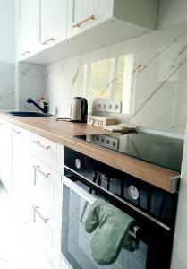 a kitchen with a stove and a counter top at Eden Apartment in Cluj-Napoca