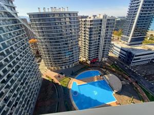 an aerial view of a large building with a pool at Solo Visit Apartments 1709 B in Batumi