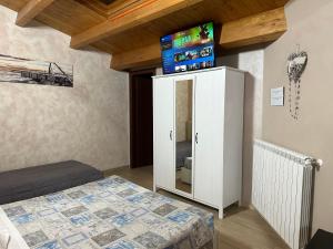 a bedroom with a bed and a white cabinet at B&B Le Mansarde in Pescara