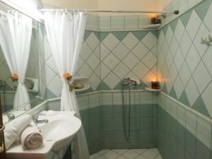 a bathroom with a sink and a shower at Eva Studios in Kassiopi +52 photos