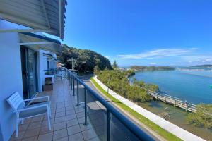 a balcony of a building with a view of the water at Estuary in Nambucca Heads