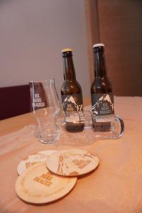 two bottles of beer sitting on top of a table at Ferienwohnung Wohlfühlen in Pfunds +7 photos