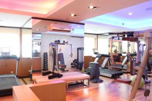 a gym with treadmills and elliptical machines at ASTON Pluit Hotel & Residence in Jakarta
