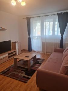 a living room with a couch and a coffee table at Two Rooms Parc Ior Apartament in Bucharest