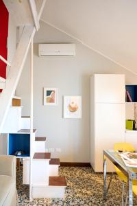 a white staircase in a living room with a table at RELSTAY - Washington Street in Milan