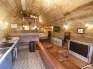 a living room with a couch and a fireplace at Foxes Den in Scarborough
