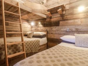 a bedroom with two bunk beds and a ladder at Foxes Den in Scarborough