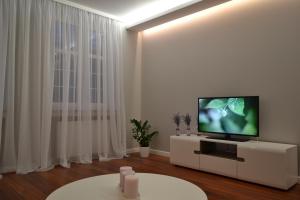 a living room with a flat screen tv on a white cabinet at Apartamenty na Starówce Grobla in Gdańsk