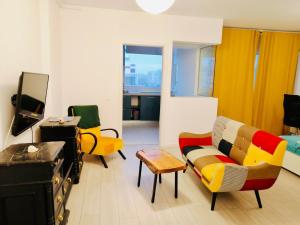 a living room with a couch and chairs and a tv at PLAZA VIEW Studio in Bucharest