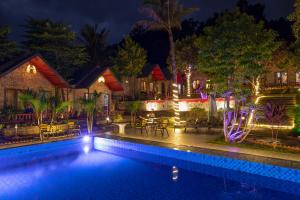 a resort with a swimming pool at night at Cat Ba Spring Garden Homestay in Cat Ba