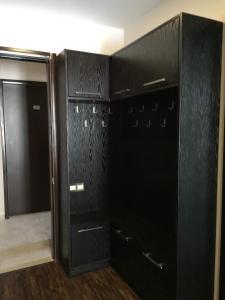 a black closet with black cabinets and a door at Baka's Apartment in Gudauri in Gudauri