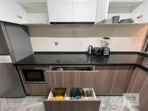 a small kitchen with white cabinets and a counter top at Palisades Peaks Luxury Apartments in Lekki
