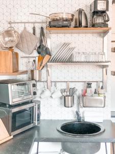 a kitchen with a microwave and a sink at Spotless Modern studio in Inglewood