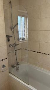 a shower in a bathroom with a glass door at Cosy 2 bed, home from home in Haddenham