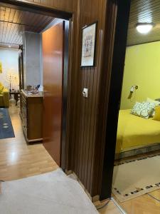 a room with a door leading to a room with a bed at Apartman SI in Banja Luka +7 photos