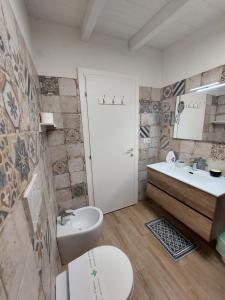 a bathroom with a sink and a toilet and a tub at B&B ARTHAS in Capilungo +44 photos