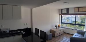 a living room with a couch and a window at Marazú OndinaApart in Salvador
