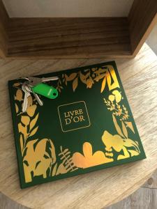 a green and yellow box with a green lighter on a table at Le ROS ÉDEN in Saint-Hilaire-de-Riez