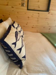 a bed with a pillow with birds on it at Powder Mill in Ponsanooth