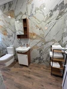 a bathroom with a sink and a toilet at Elegant and cozy room ARAKS in Kostinbrod