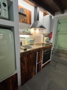 a kitchen with a sink and a stove at Casa da Linha in Amarante