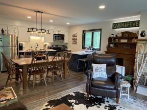 a kitchen and dining room with a table and chairs at Mountain Condo with Modern Cabin Style in East Jewett