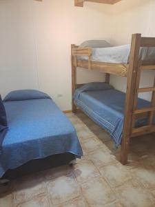 a room with two bunk beds and a tiled floor at NEUQUEN alojamiento in Neuquén