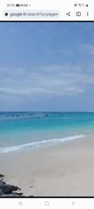 a screenshot of a beach with a picture of the ocean at SOL AZUL in Santa Maria